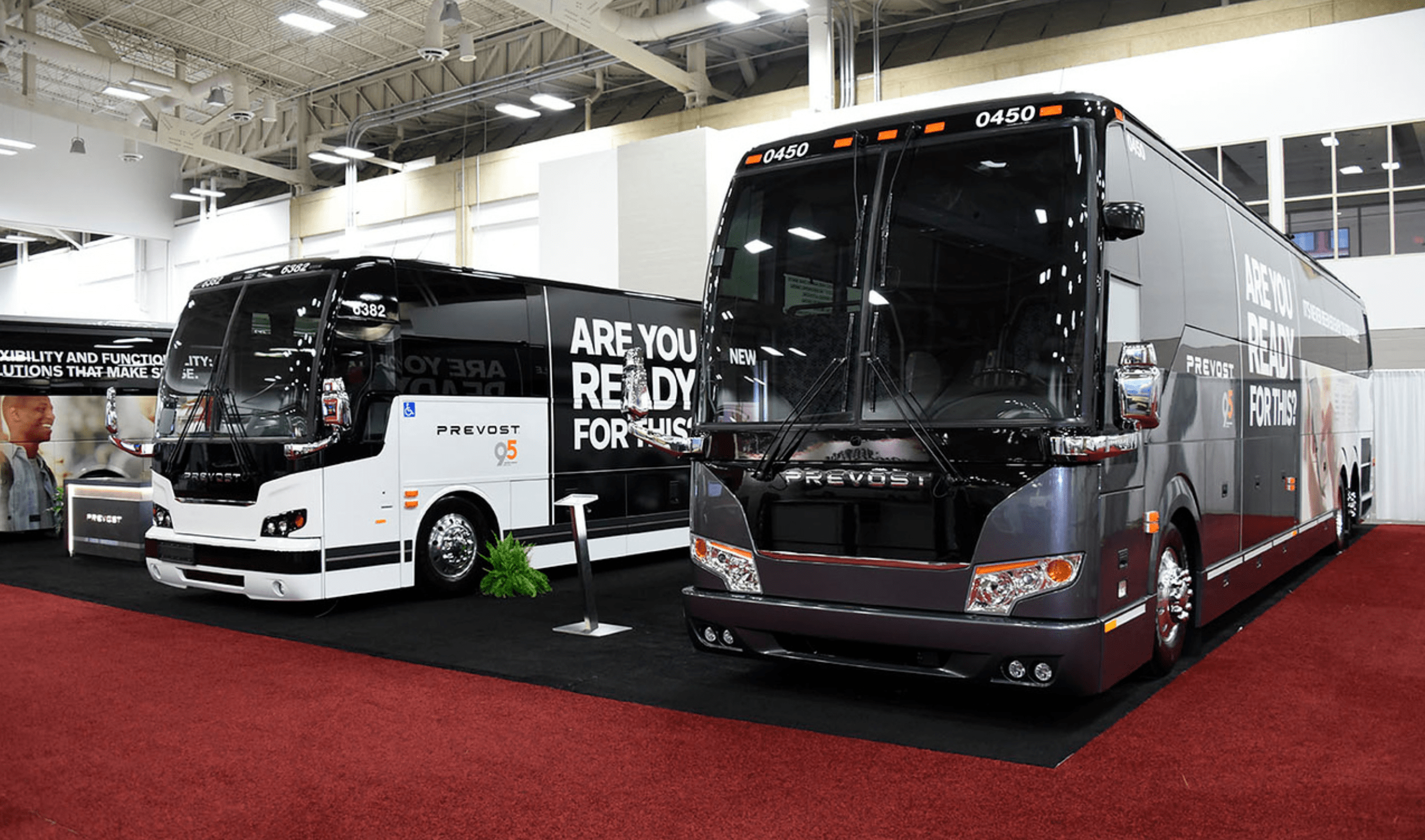 Prevost motor coaches on display at an industry trade show