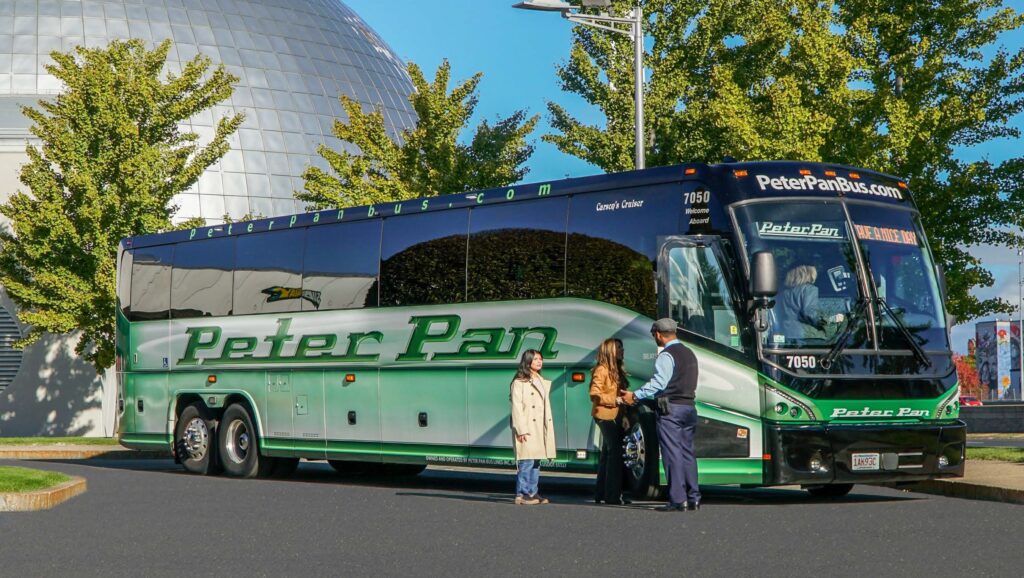 A Peter Pan Bus Lines motorcoach with travellers boarding