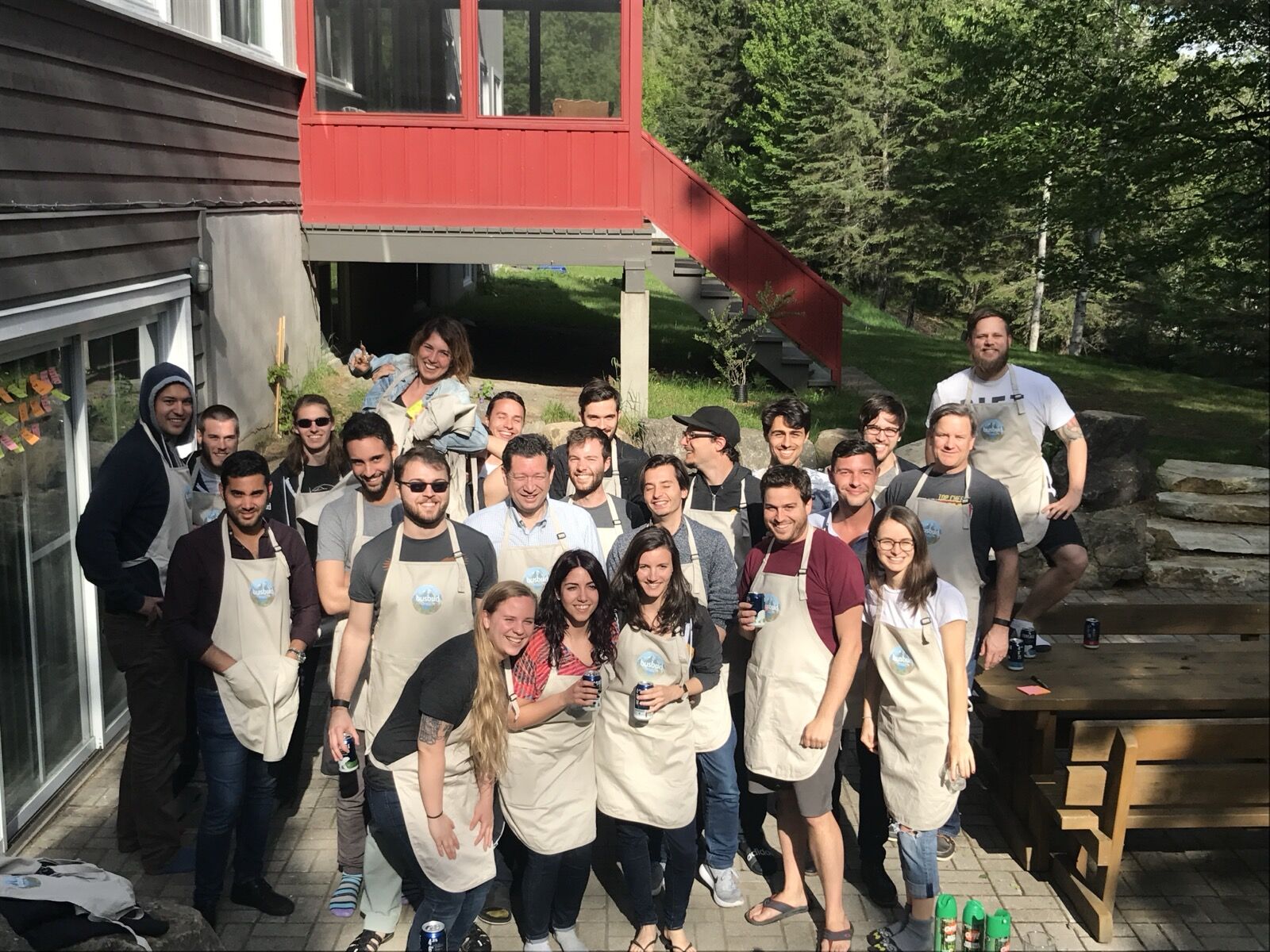 The team cooking together in aprons at a company offsite