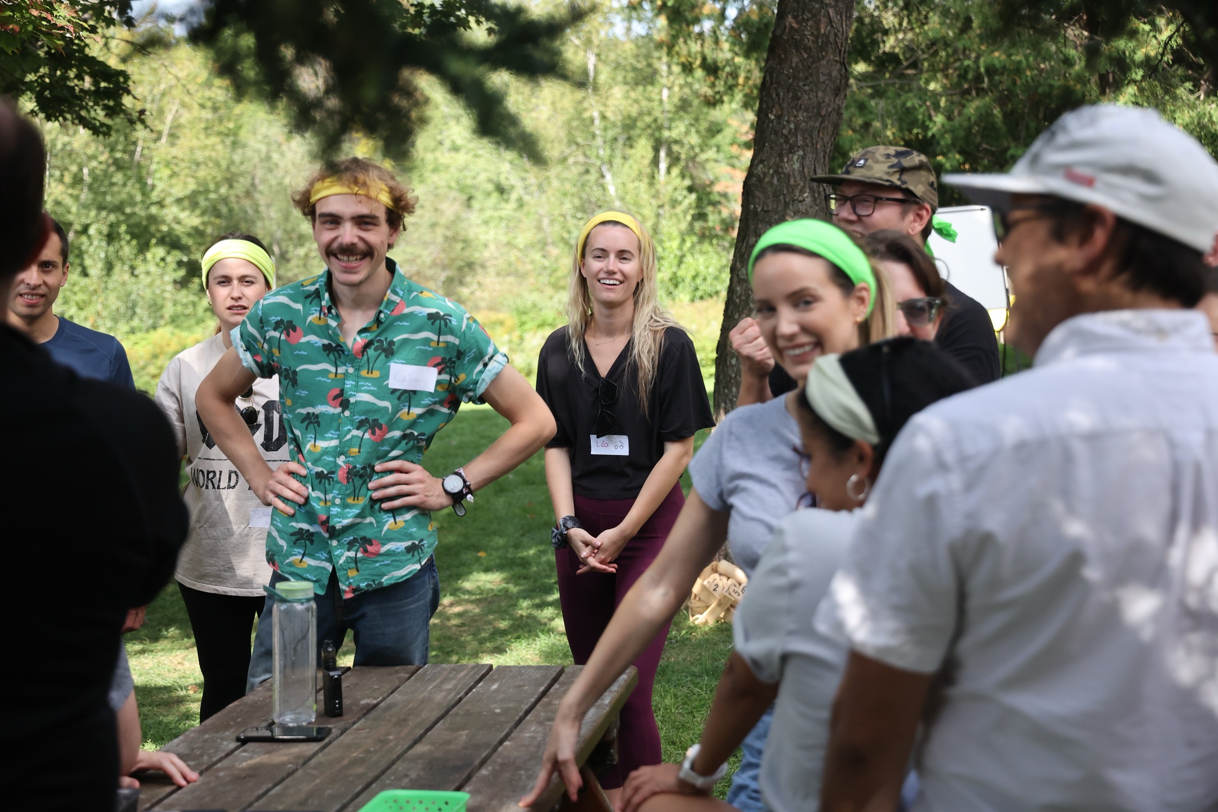 The team wearing colorful headbands and laughing during a team-building game at a company offsite
